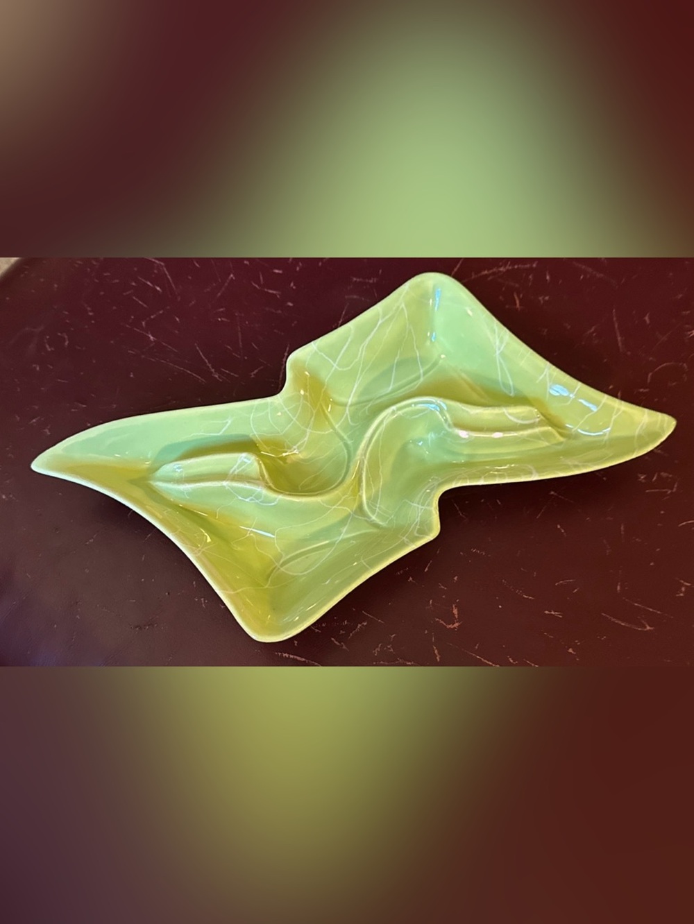 Green MCM boomerang shaped ashtray with white raised ‘drizzle’ type overlay.